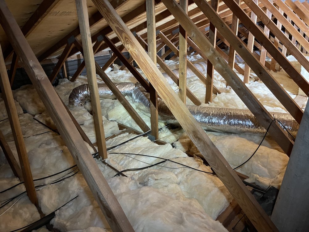 Attic insulation being installed by TX Builder