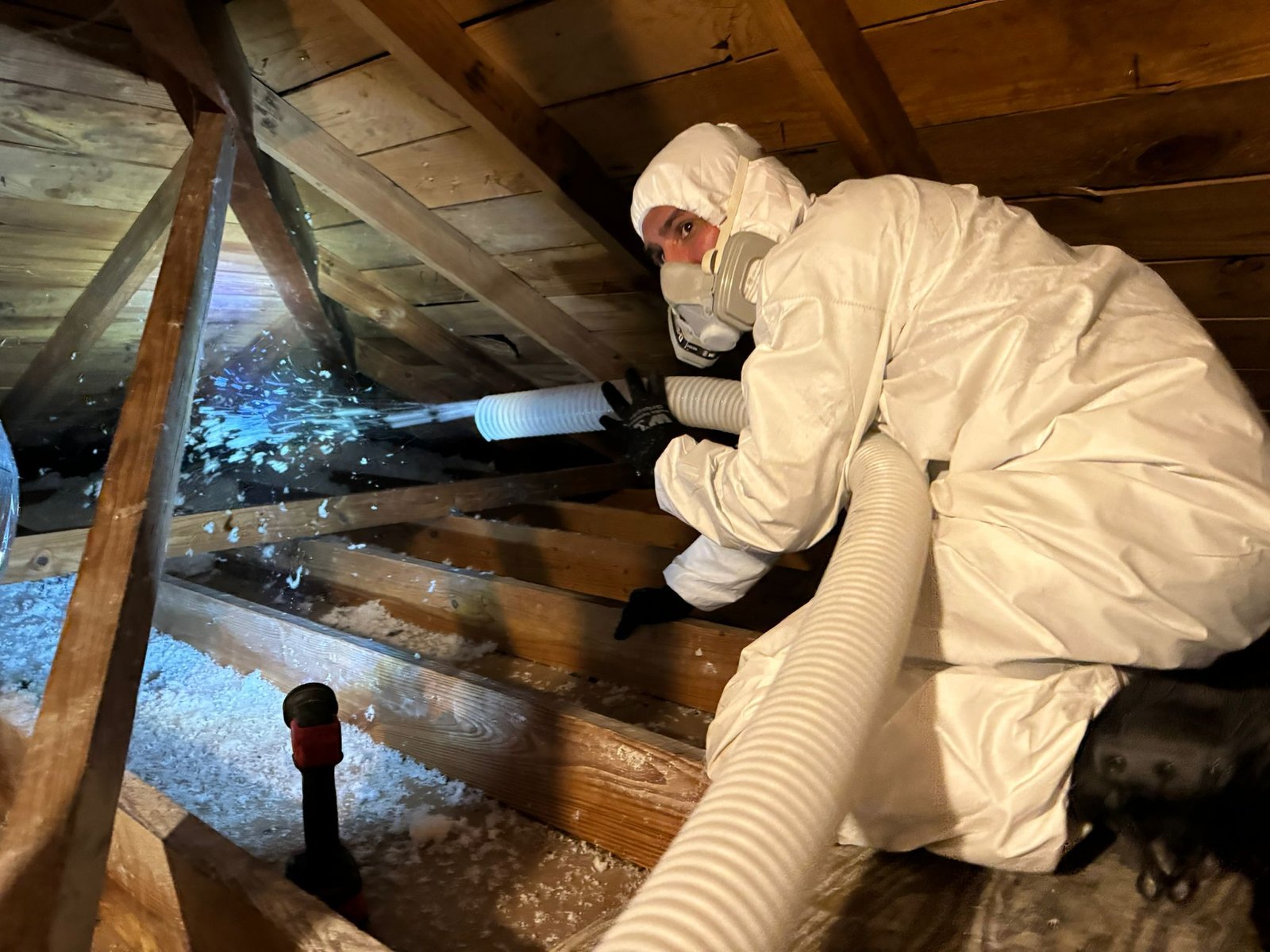 TX Builder technician working in an attic